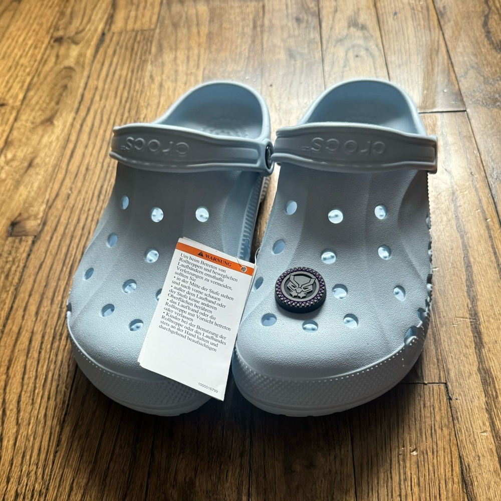 CROCS Unisex Clogs, Size M8/W10- Baby Blue. 
Black Panther Jibbit included.